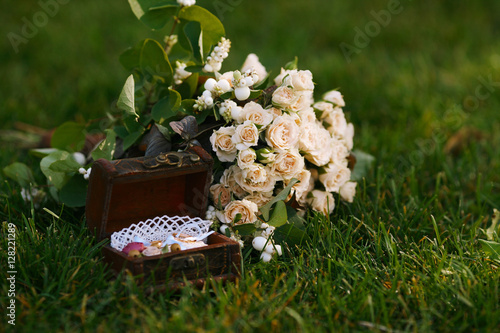 Wedding bouquet of small roses. Wedding rings photo