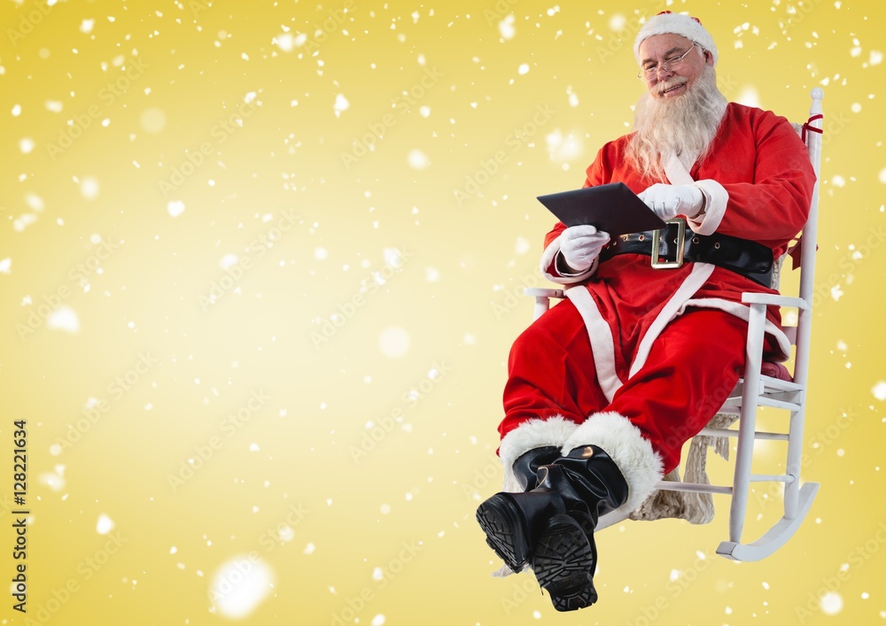 Santa sitting on chair and using digital tablet Santa sitting on chair and using digital tablet