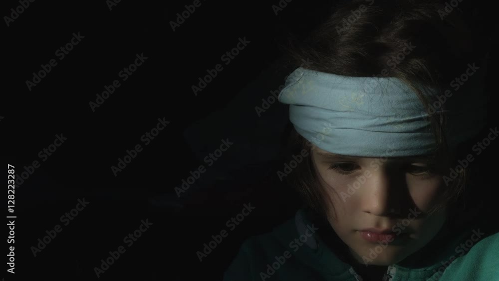 4k shoot of a cute child posing with a bandage on his head 4k shoot of a cute child posing with a bandage on his head