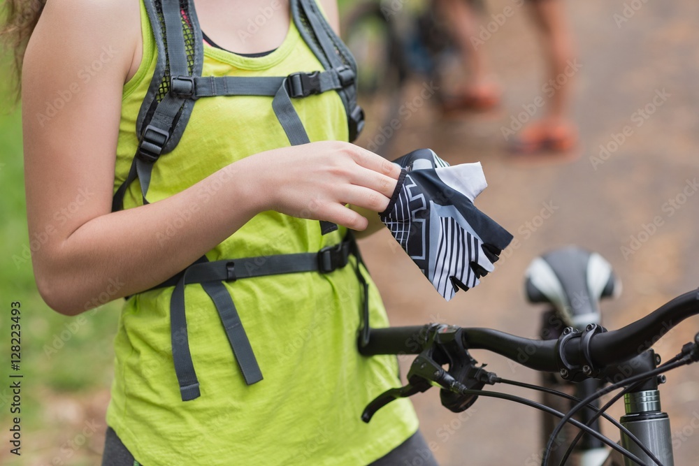 Mid section of female biker wearing gloves Mid section of female biker wearing gloves