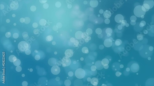 Bokeh holiday background with floating particles against a teal blue backdrop
