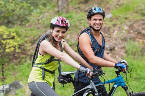 Young man and woman with bikers in forest