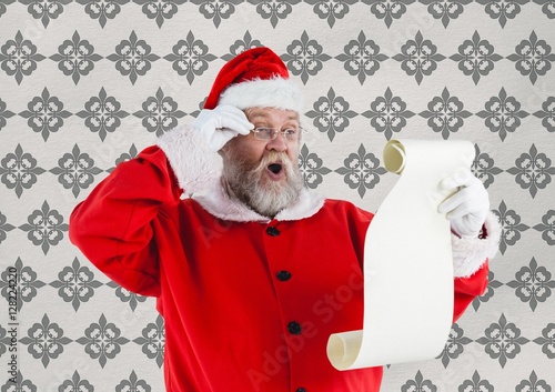 Surprised santa claus looking at wish list