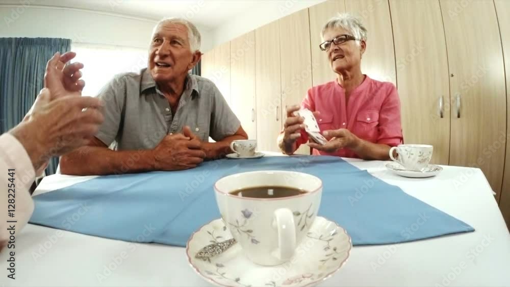 Senior man and woman playing cards in old age home Senior man and woman playing cards in old age home