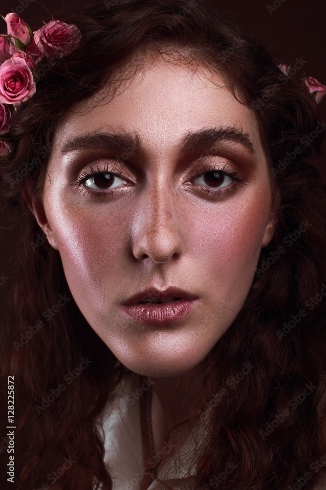 Fototapeta premium Portrait of a beautiful girl with freckles and light wear make up