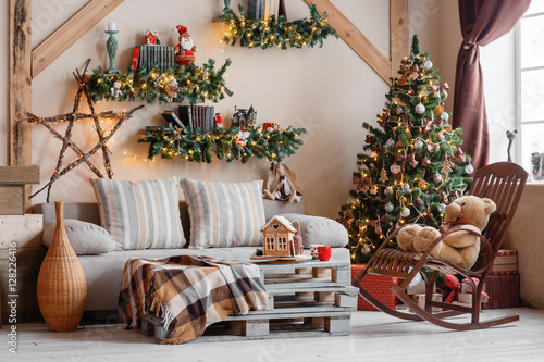 Obraz na plátně Calm image of interior modern home living room decorated christmas tree and gifts, sofa, table covered with blanket