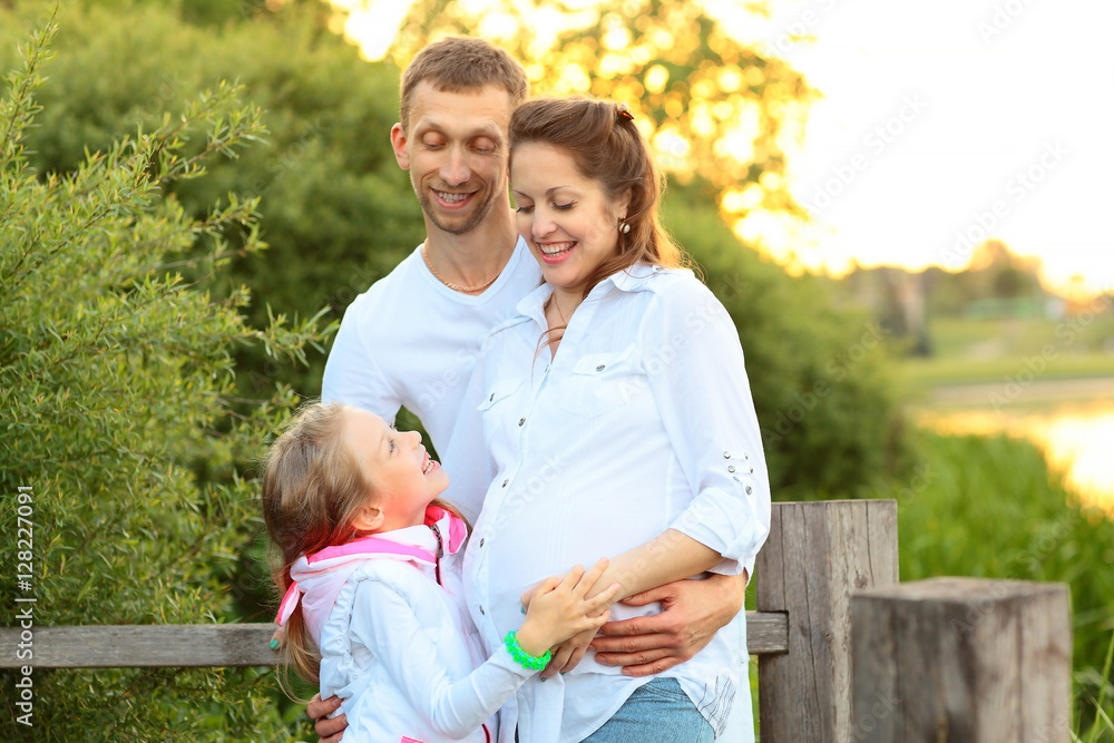 happy family father mother and daughter relaxing in the Park happy family father mother and daughter relaxing in the Park