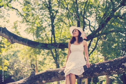 Young teen girl sitting on tree