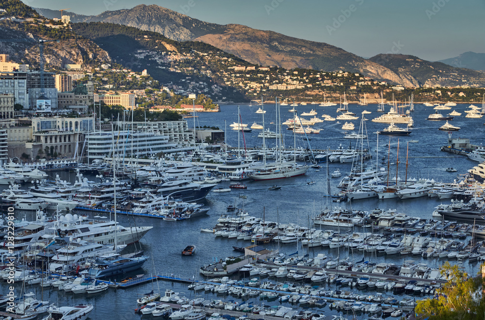 World Fair MYS Monaco Yacht Show, Port Hercules, luxury megayachts, many shuttles, taxi boat, presentations, Journalists, boat traffic, Azur water, aerial view, cityscape, mountains on background