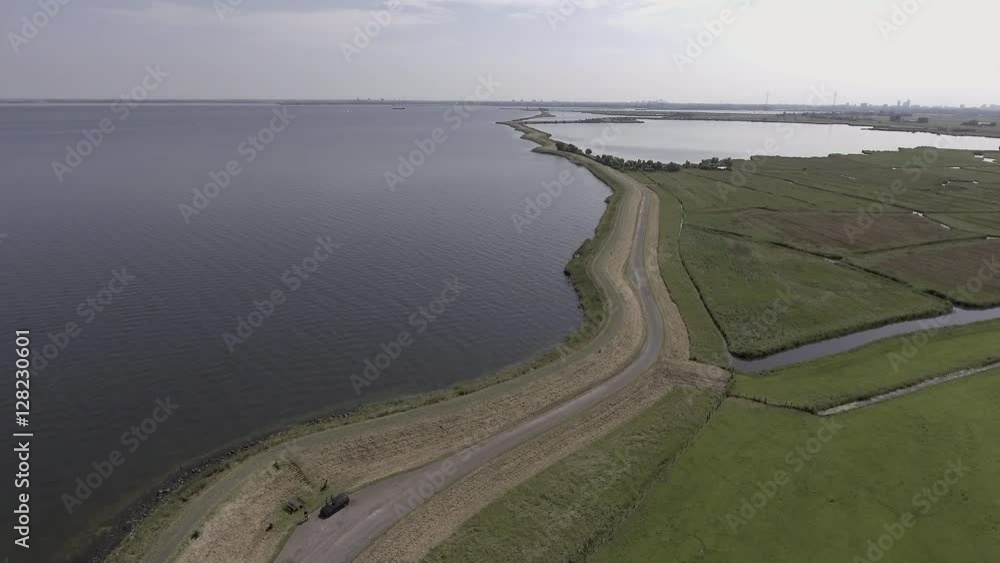 Aerial of winding dike by great lake called 'IJsselmeer' in Holland. Aerial of winding dike by great lake called 'IJsselmeer' in Holland.