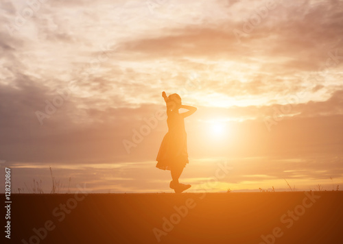 a silhouette of a happy young girl child the arms of his loving