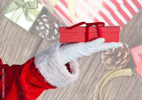Hand of santa claus holding christmas gift