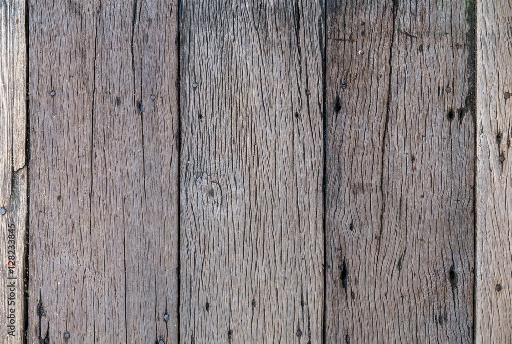 Old plank wooden wall background damaged by time and insects Old plank wooden wall background damaged by time and insects
