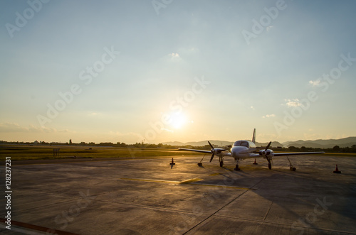 Small Airplane or Aeroplane Parked at Airport.Small Airplane Famous to use Private Airplane.Sunset Light and Mountain View.