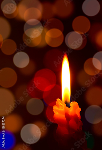 Burning candle with soft focus lights or Bokeh