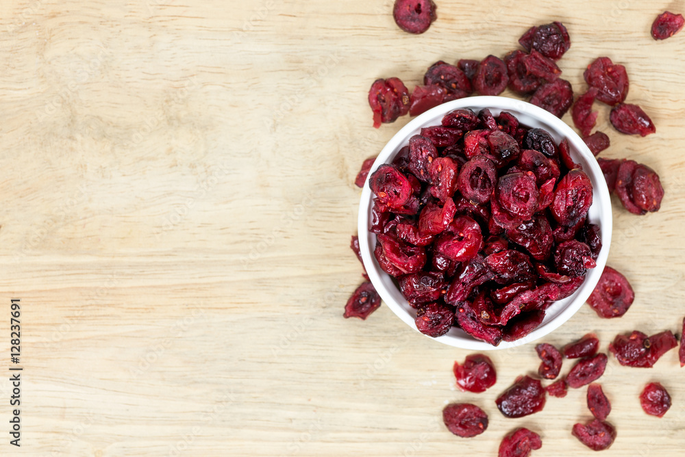 dried cranberries in a bowl on wooden background.
dried cranberries in a bowl on wooden background.