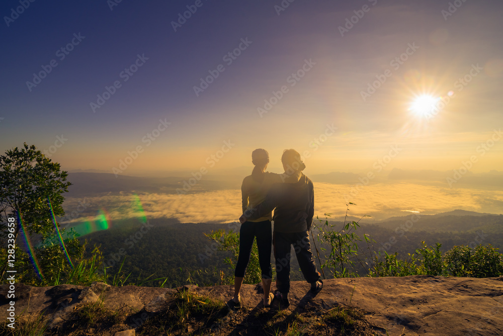Hiking couple happy to reach the top of a mountain Hiking couple happy to reach the top of a mountain