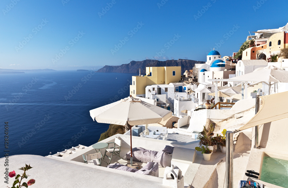 Greece. Santorini Island. Oia village. Traditional Greek white houses on the hill. A small swimming pool in the guest house