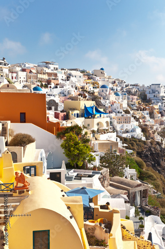 Greece. The beautiful island of Santorini. Traditional houses with round roofs in the Oia villageon the steep coast