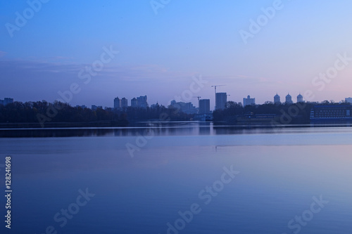 Morning on the Dnieper River. View of the right bank. You can see the high-rise buildings on the horizon