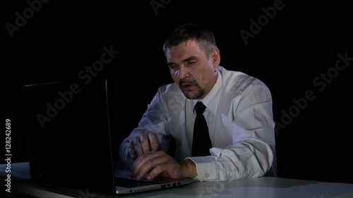 Office worker asleep in front of a laptop screen