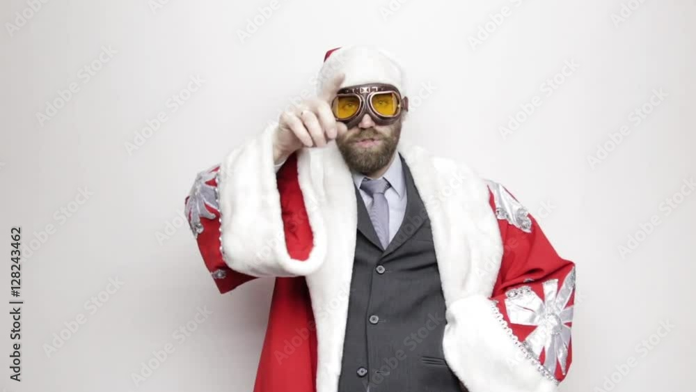 businessman in a suit of Santa Claus raised hand to his eyes and looks into the distance