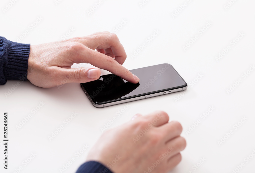 Hand using smart mobile phone on wooden table and light blurred background
Hand using smart mobile phone on wooden table and light blurred background