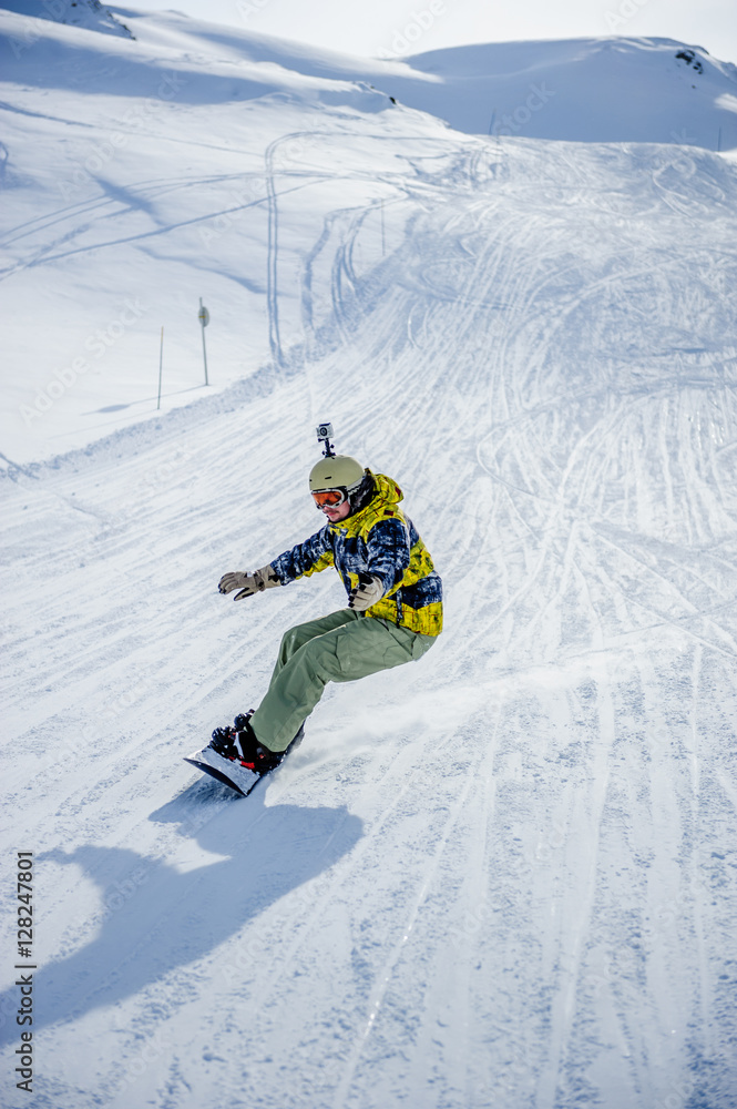 Snowboarder riding at French Alps mountain slopes Snowboarder riding at French Alps mountain slopes