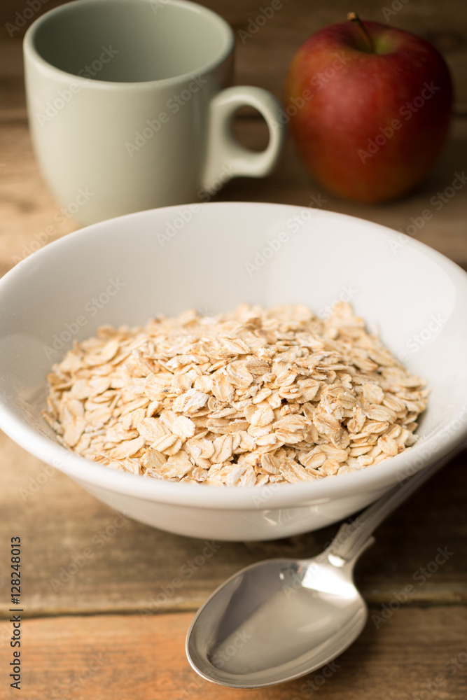 Bowl of Raw Porridge Oats on Wooden Background Bowl of Raw Porridge Oats on Wooden Background