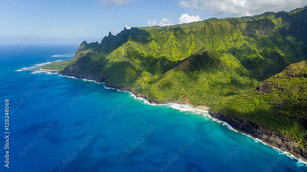 Aerial view on Na Pali Coast with Hanakapiai Beach, Kauai, Hawaii. Kee Beach is in the background. Kalalau trail is visible if zoomed in. Aerial shot from a helicopter.