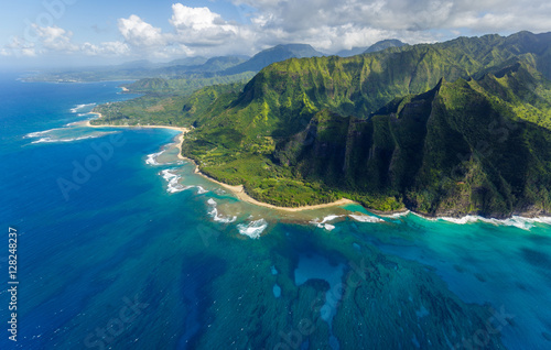 View on the mountains of Kauai's north coast with Kee Beach and the reef from Kailio Point. Aerial shot from a helicopter, Kauai, Hawaii. photo