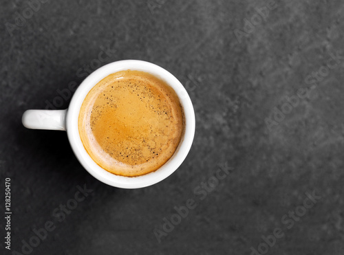 White cup of espresso coffee on background
