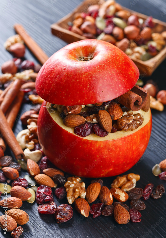 Red juicy apple with assorted nuts , raisins and cinnamon Red juicy apple with assorted nuts , raisins and cinnamon