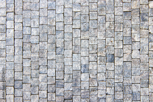 Granite cobblestone pavement background, stone textured pattern photo