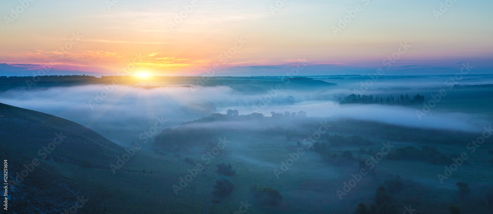 landscape of dense fog in the field at sunrise