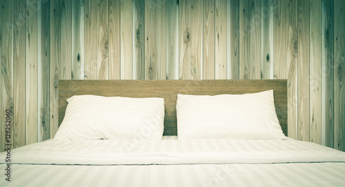 white bedding and pillow in hotel room , vintage