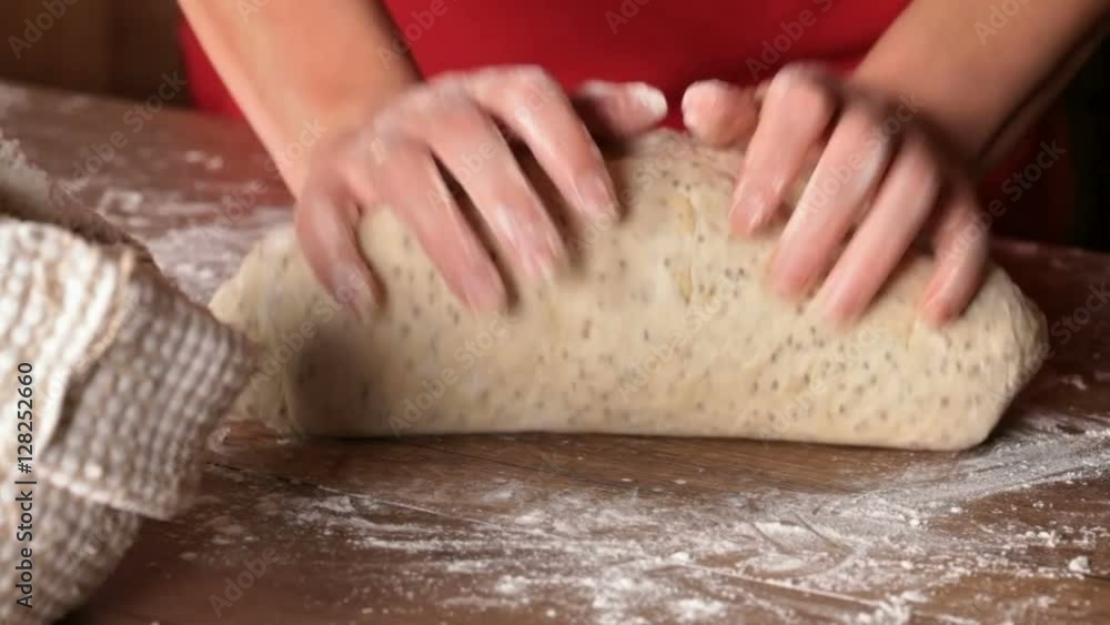 Baker shaping the dough before portioning Baker shaping the dough before portioning