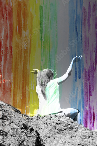 Girl with arms raised above the head, double exposure with rainb photo