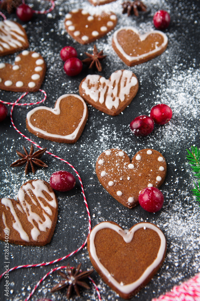 Christmas gingerbread cookies with festive decoration on black stone background, selective focus. Holiday concept Christmas gingerbread cookies with festive decoration on black stone background, selective focus. Holiday concept