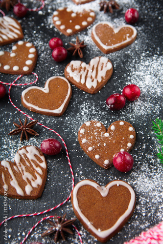 Christmas gingerbread cookies with festive decoration on black stone background, selective focus. Holiday concept