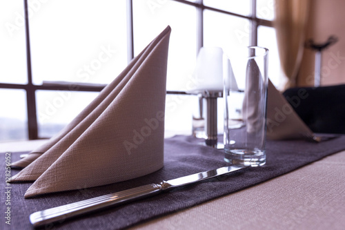 Napkin knife and empty glass with in fine dining restaurant