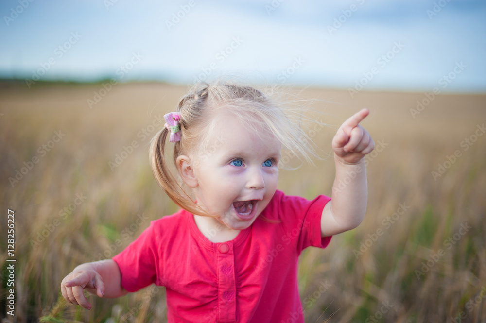 The child having fun playing in a rye field
