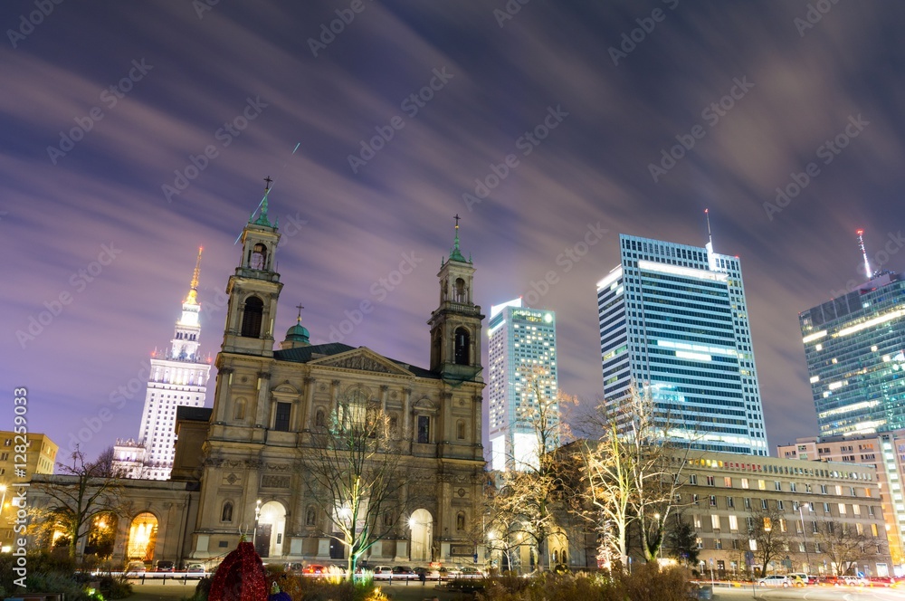 Obraz premium view on old church and modern skyscrapers in Warsaw at night, Poland