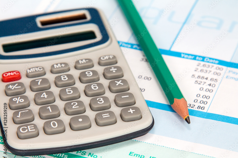 Payroll with calculator and pencil Payroll with calculator and pencil