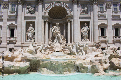 Summer day view of Fontana Di Trevi in Rome. Aqueduct-fed rococo fountain, designed by Nicola Salvi & completed in 1762, with sculpted figures.