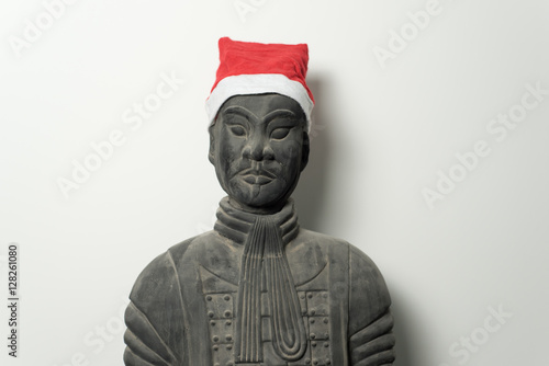 Chinese terracotta warrior statue with santa hat isolated on white background