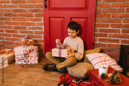 The boy opens a gift