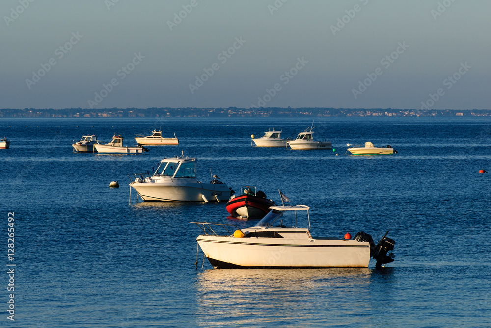 boats parked on water in the morning waiting for their owner to part with them on the seq