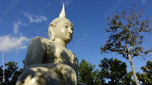 The buddha statue with cold moving on blue sky