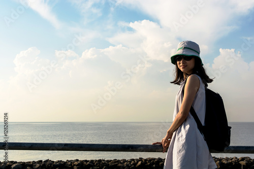 traveler girl looking at the sea side with blue sky, travel and
